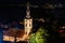 Cityscape of Zemun and St. Nicholas church at night.