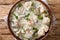 Ciulama de pui is a Romanian creamed chicken dish with mushrooms closeup in the bowl. Horizontal top view