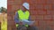 Civil engineer architect specialist analyzing blueprints to control working at construction site