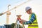 Civil engineer inspects work using radio communication with the management team in the construction area