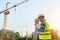 Civil engineer inspects work using radio communication with the management team in the construction area