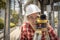 Civil engineer land survey with tacheometer or theodolite equipment. Worker Checking construction site on the road. Surveyor