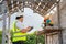 A civil engineer is supervising a construction worker laying bricks at a construction site