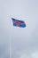 A civil flag and ensign Iceland against a clouded sky.