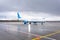 Civil passenger airplane lining up the runway prior to departure, taxiing on wet asphalt