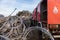 A civil protection truck next to a pile of wire rope coils in a junkyard