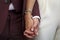 Civil wedding bride and groom holding hands