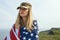 Civilian woman in her husband`s military cap. A widow with a flag of the united states left without her husband. Memorial Day to