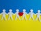 Civilians of Ukraine hold hands with heart icon on background of Ukrainian flag