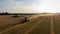 Claas 8900 harvester combine offloading to tractor in the field in Faxe, Denmark