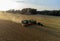 Claas 8900 harvester combine offloading to tractor in the field in Faxe, Denmark