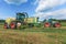 Claas harvester and a Fendt 926 with a Krone ZX400GL trailer works on a field