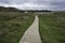 Clachtoll Beach wooden boardwalk on a cloudy day