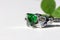 Claddagh ring with green emerald. Traditional Irish ring in shape of two hands holding a heart shaped green gemstone.