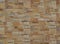 Cladding wall for exterior made of stoneware with rocks effect. Colors are shades of brown.
