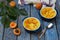 Clafouti with apricots in rameken on blue wooden background. Fruits clafoutis. Sweet casserole. Traditional French cake. Copy spac