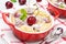 Clafoutis with cherries in red ramekin, close-up