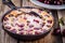 Clafoutis cherry pie on wooden background