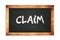 CLAIM text written on wooden frame school blackboard