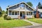 Clapboard siding house exterior. Large entance porch with brick