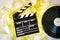 Clapper board with 35mm film yellow frames and movie reel