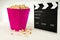 Clapperboard, popcorn on a white background