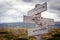 clarity is power text engraved on old wooden signpost outdoors in nature