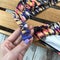 Clasp of a multi-colored leotard on a wooden background