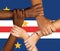 Clasped hands on the background of the flag of Cape Verde