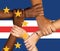 Clasped hands on the background of the flag of Cape Verde