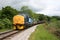 Class 37 locomotives numbers 37682 and 37025 approaching Mytholmes, Keighley and Worth Valley Railway, West Yorkshire, UK - June