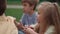 Class of multi ethnic pupils having lunch on schoolyard