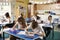 Class of primary school kids studying in a classroom