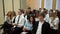 A class on a university listening a teacher. Group of students in a classroom, listening as their teacher holds a