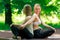 Classes with an individual yoga trainer in the park on a sunny summer day