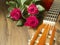 Classic acoustic guitar on a wooden floor and bouquet of red rosses. Expression of gratitude and love for great music performance