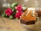 Classic acoustic guitar on a wooden floor and bouquet of red rosses. Expression of gratitude and love for great music performance