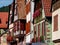 Classic Alsatian windows in a half-timbered house, decorated with wooden carvings and flowers