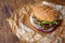 Classic american burger, fast food on wood background