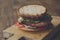 Classic american burger, fast food on wood background