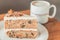 Classic American Carrot Cake with cream cheese frosting and a cup of hot latte