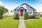 Classic American house with siding trim and red entry door