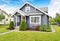 Classic American house with siding trim and red entry door