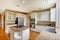 Classic American kitchen interior with white cabinets and built-in stainless steel fridge.