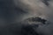 Classic Autumn Slovenian Landscape In Dark Colors With A Small Church On Top Of A Mountain Among Thunderclouds. Shot Near The Famo