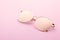 Classic aviator mirrored flat lens sunglasses with golden metal frame closeup on pink background