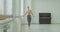 Classic ballet dancer exercising temps leve at barre