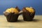 Classic banana nut muffins in black paper wrapper on wooden table