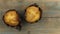 Classic banana nut muffins black paper wrapper on wooden table. Top view