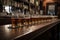 classic bar scene with row of draught beers and shot glasses on the counter